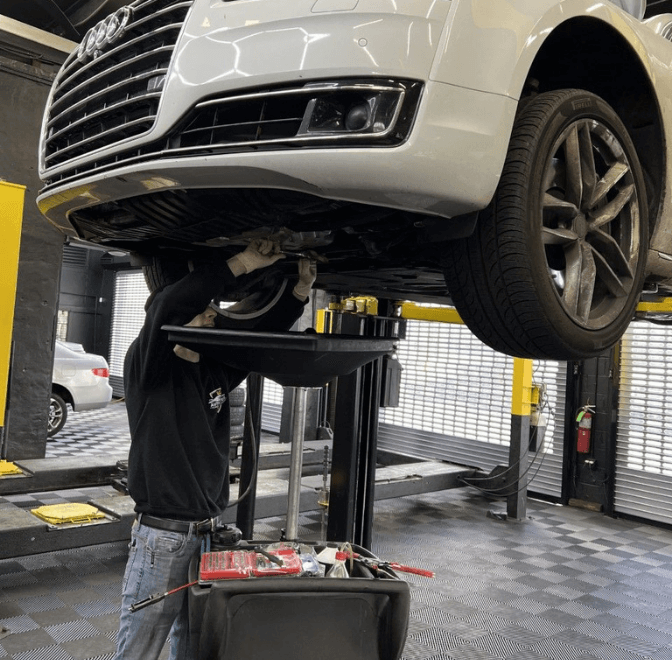 An auto technician performs an oil change at EG Auto Center in Dayton, NJ