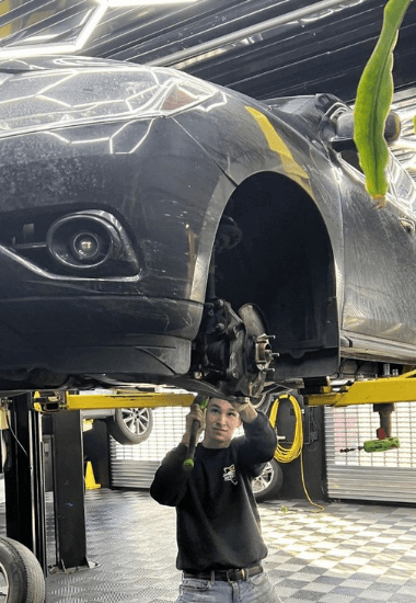 An Auto technician works on the shocks and struts of a vehicle at EG Auto Center in Dayton, NJ