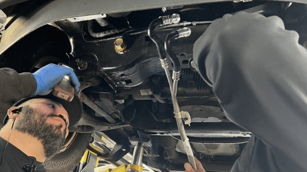 Transmission service being done by two auto technicians at EG Auto Center