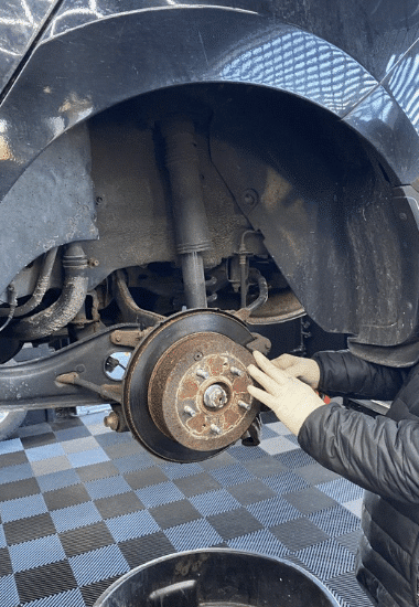 An EG Auto Center auto technician performs brake repair and service on a vehicle